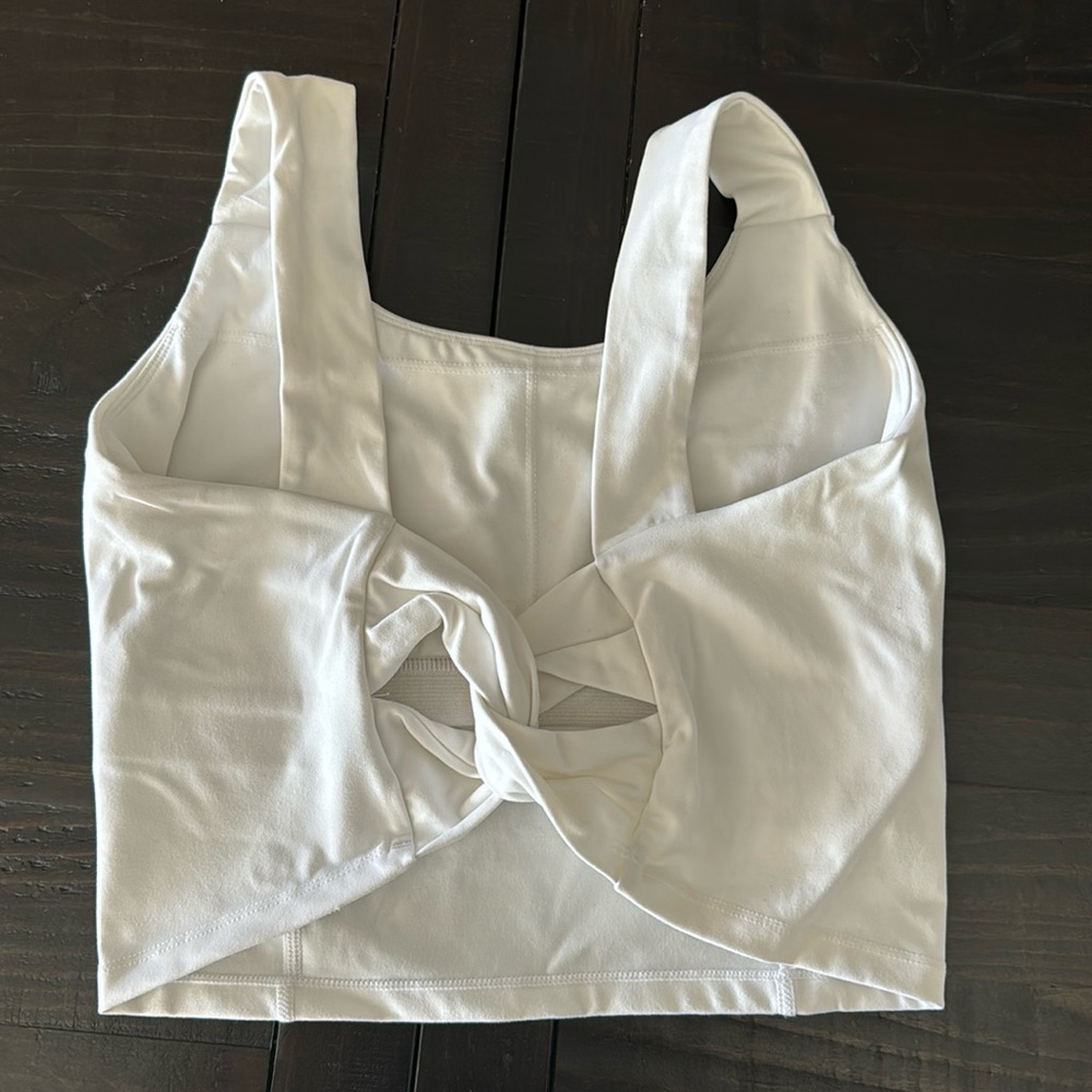 White HALARA shelf bra crop top. Size unknown measurements shown, I’d guess med.